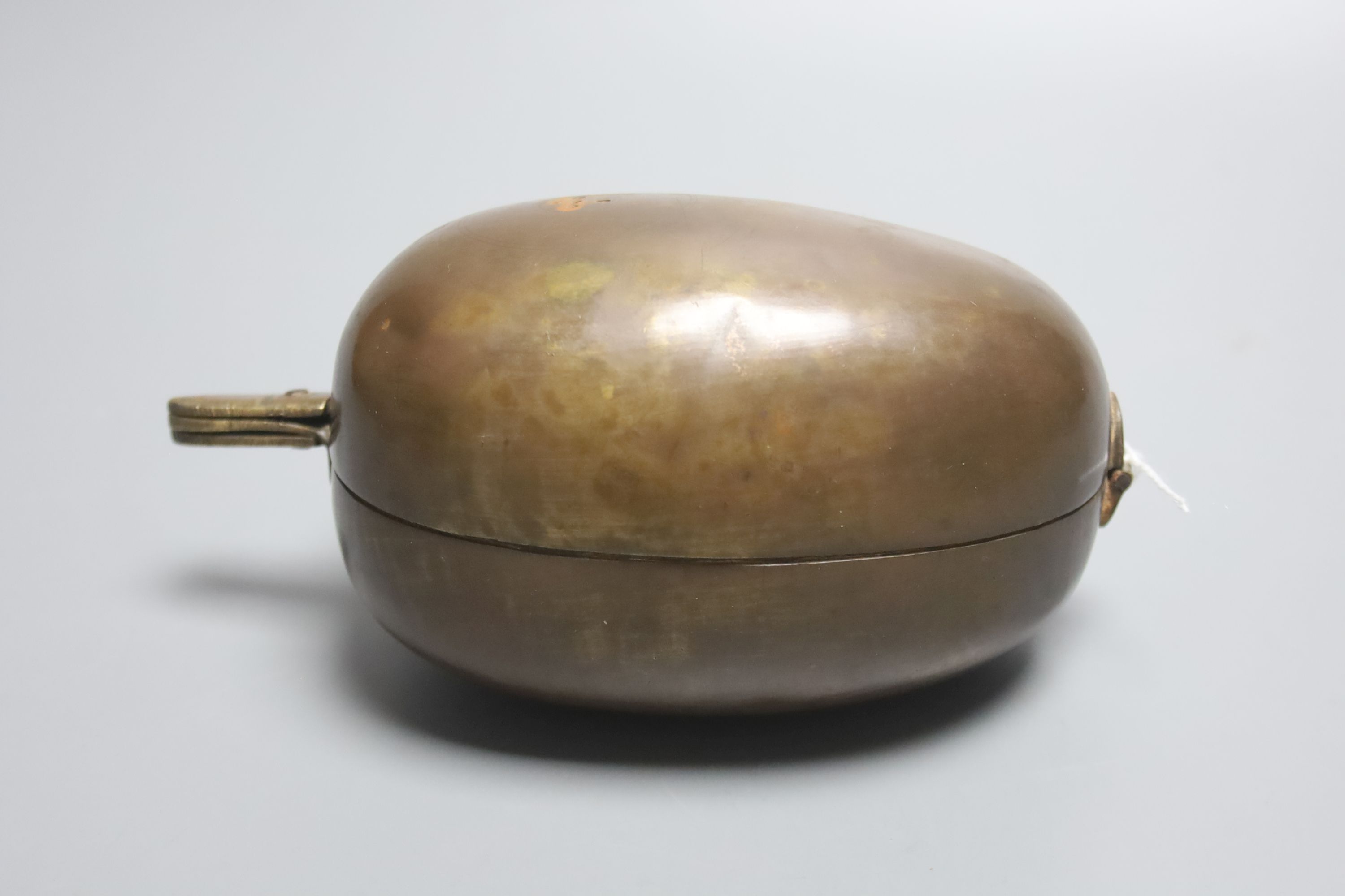 A late 19th / early 20th century Indian lidded brass spice box, tear shaped with a hinged cover revealing a divisional interior, 16cm l